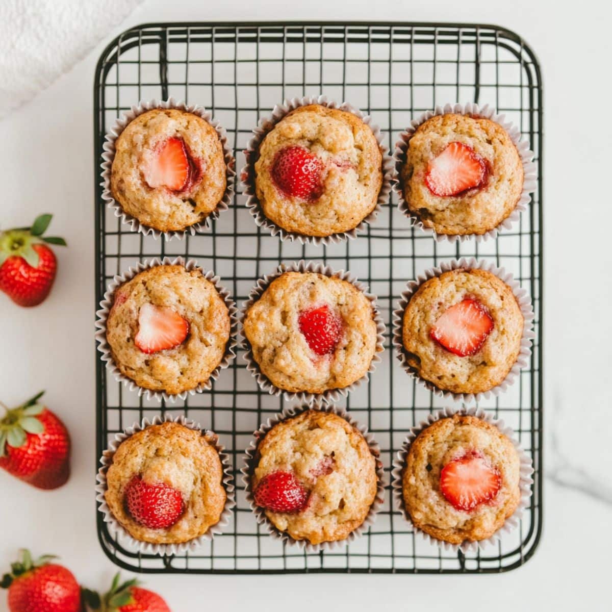 Strawberry banana muffins cooling on a wire rack	