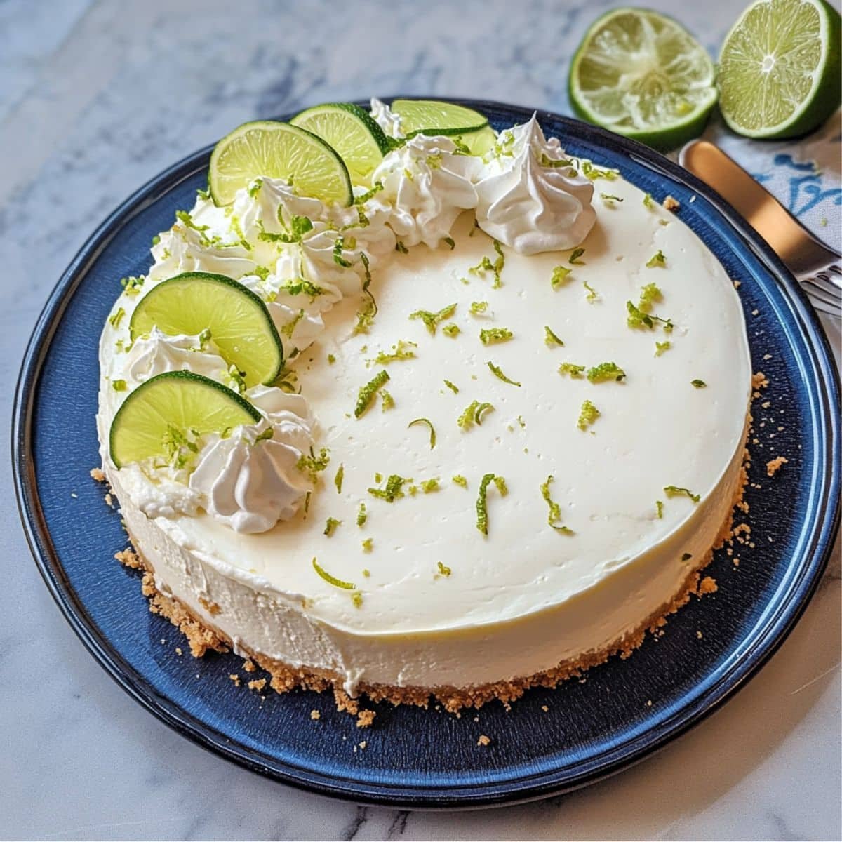 No Cook Key Lime Cheesecake with whipped cream and lime slices	