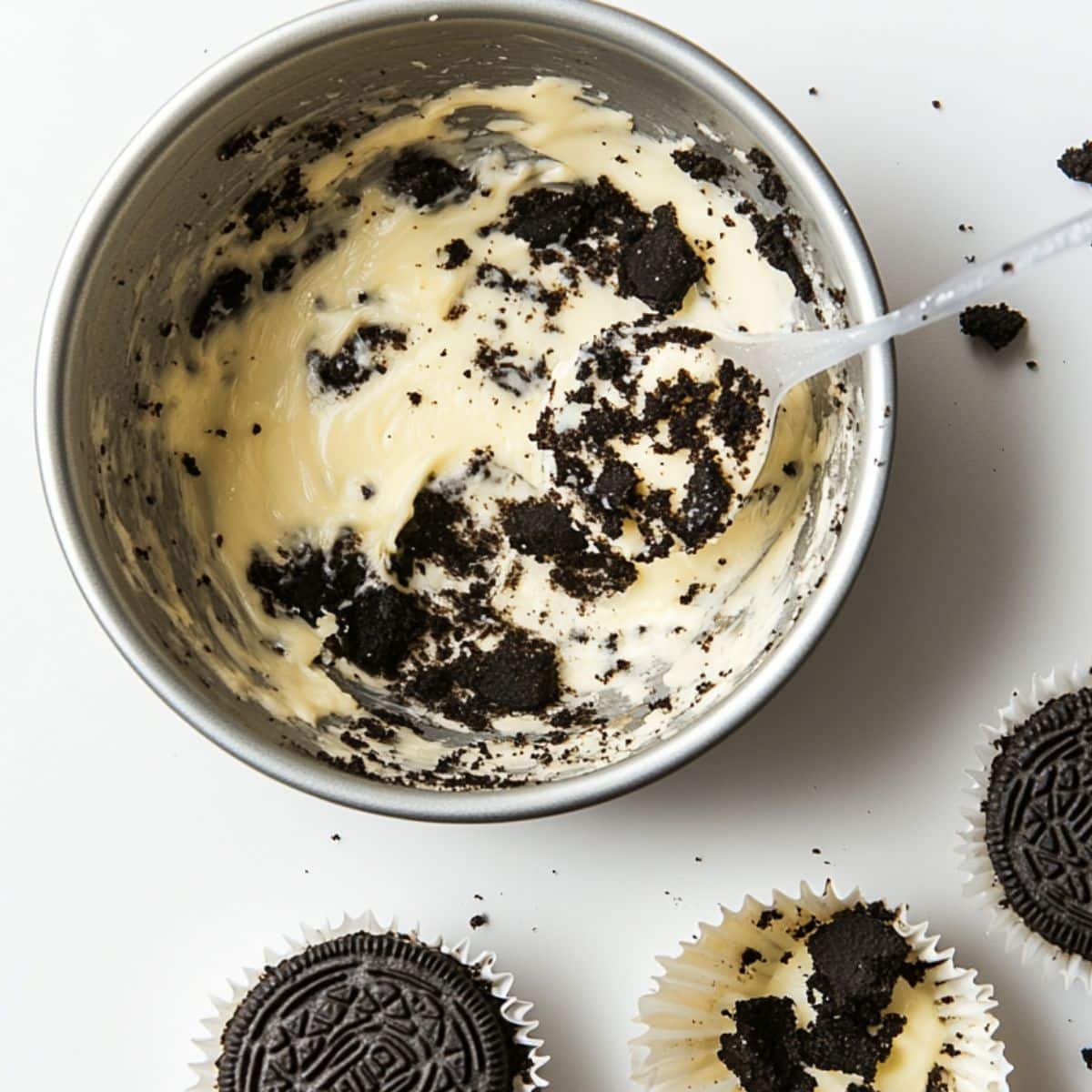 Pressing Oreo crust into cupcake liners for mini cheesecakes	