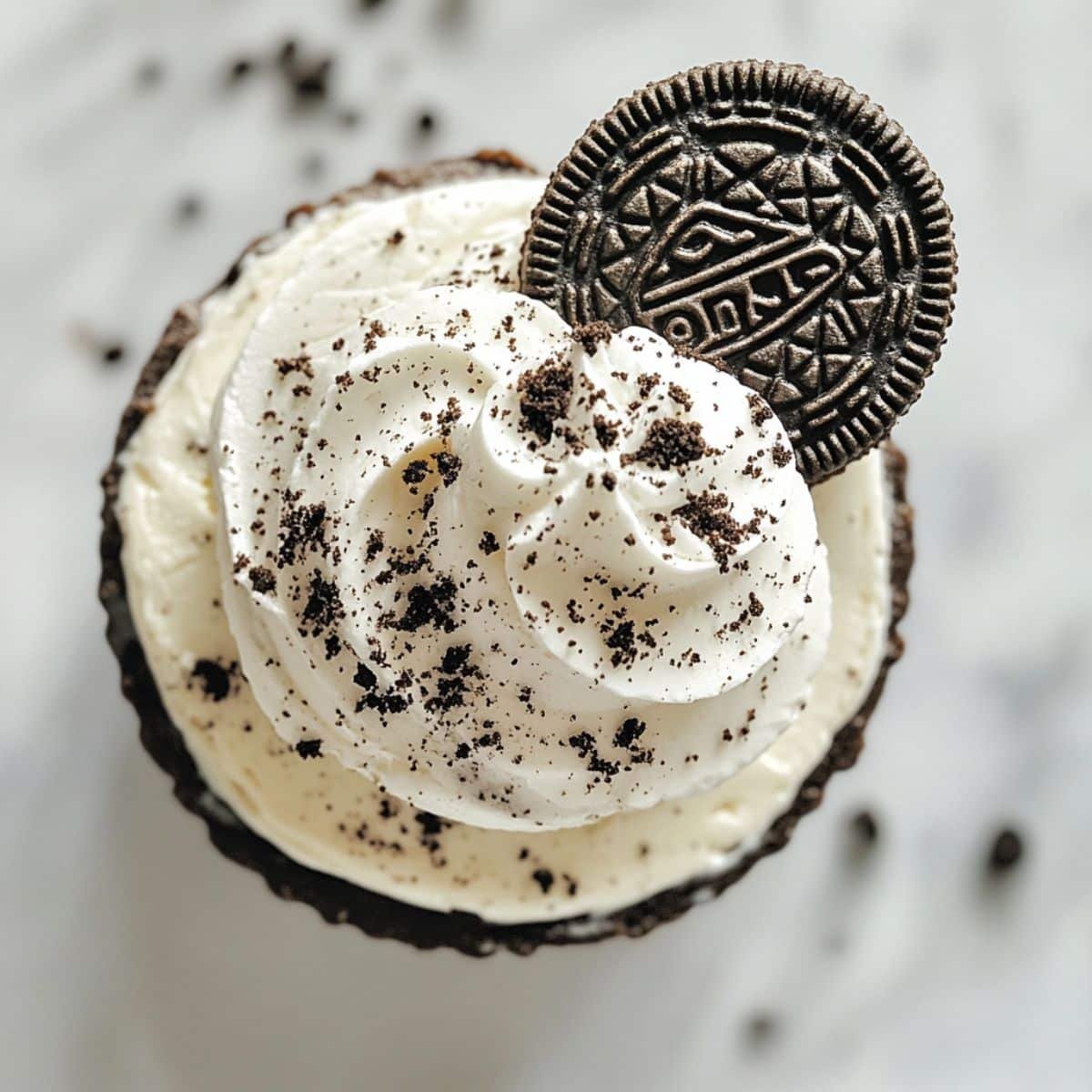 No-Bake Mini Oreo Cheesecake topped with whipped cream and Oreo	
