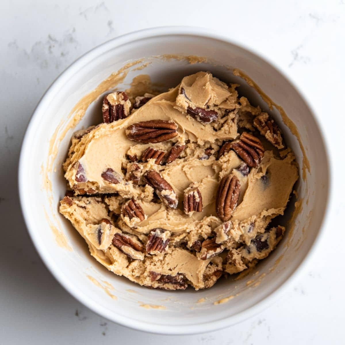 Brown butter pecan cookie dough in a mixing bowl