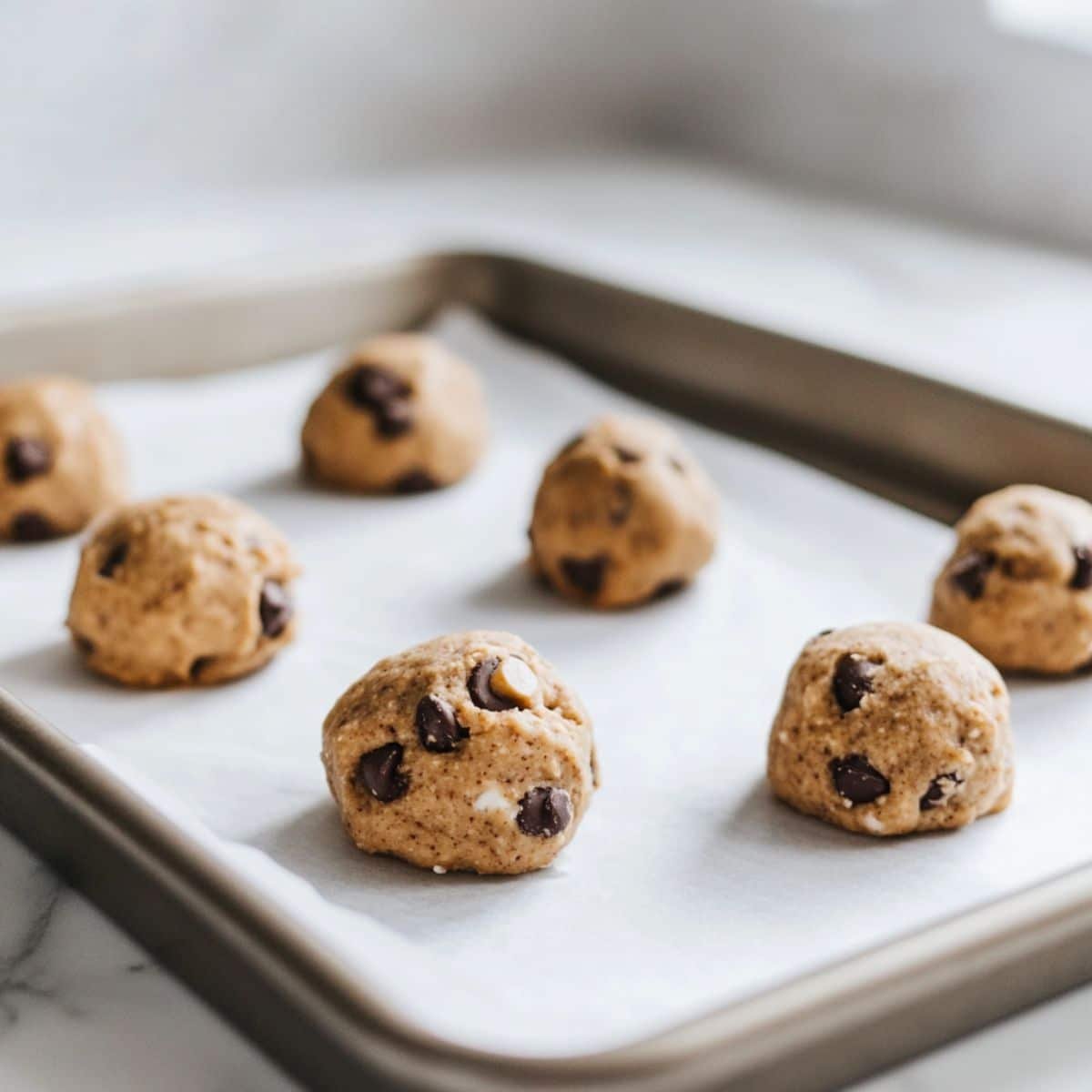 Scooping cookie dough onto a baking sheet	