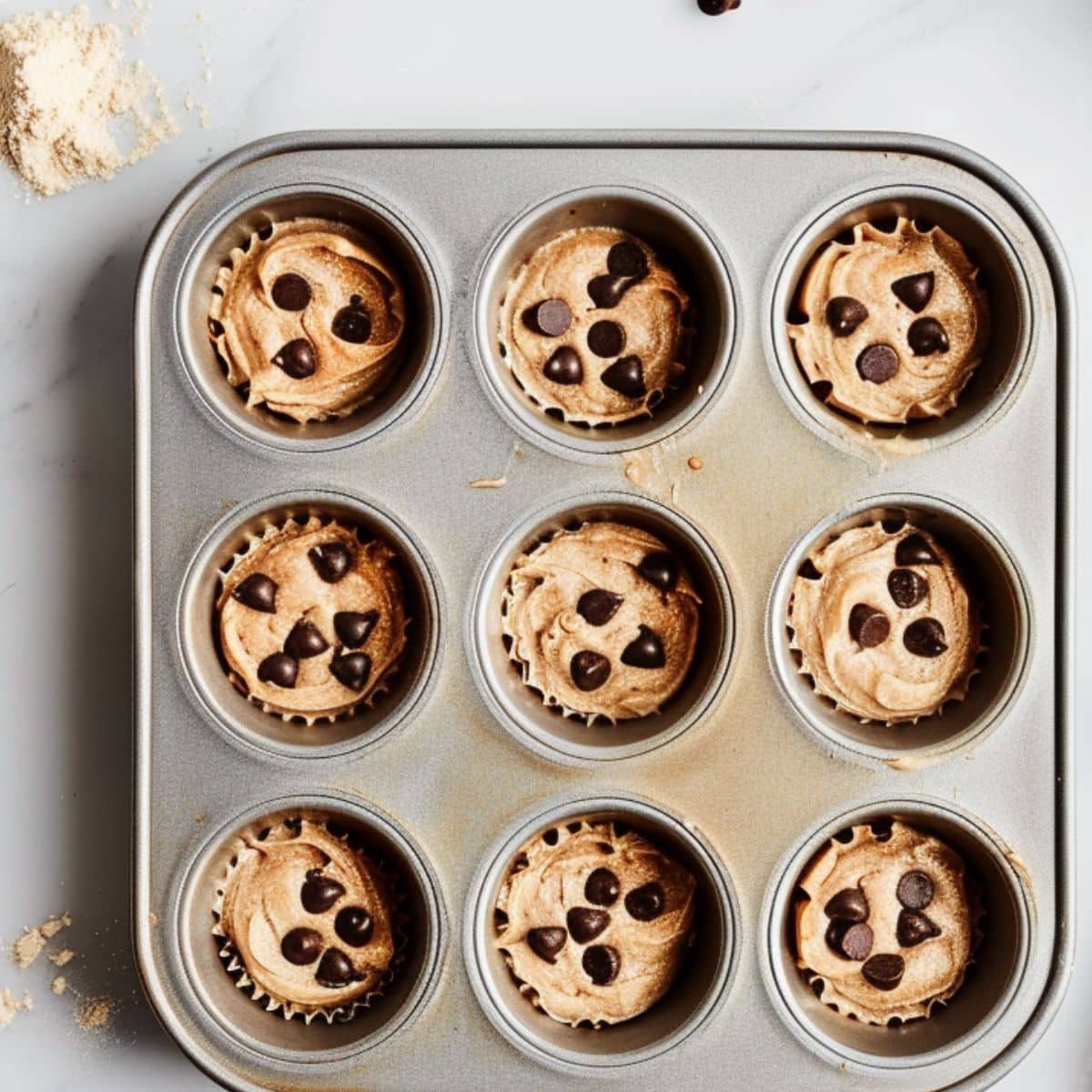 Mini muffin tin filled with batter and ready to bake	
