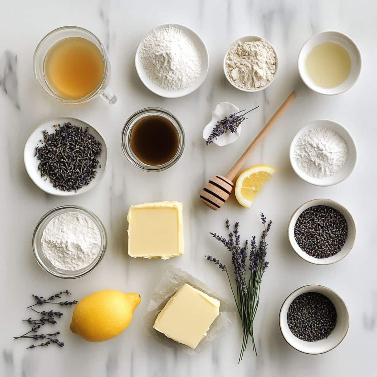 All ingredients for Earl Grey cake laid out on white kitchen counter. Includes tea leaves, butter, sugar, milk, eggs.