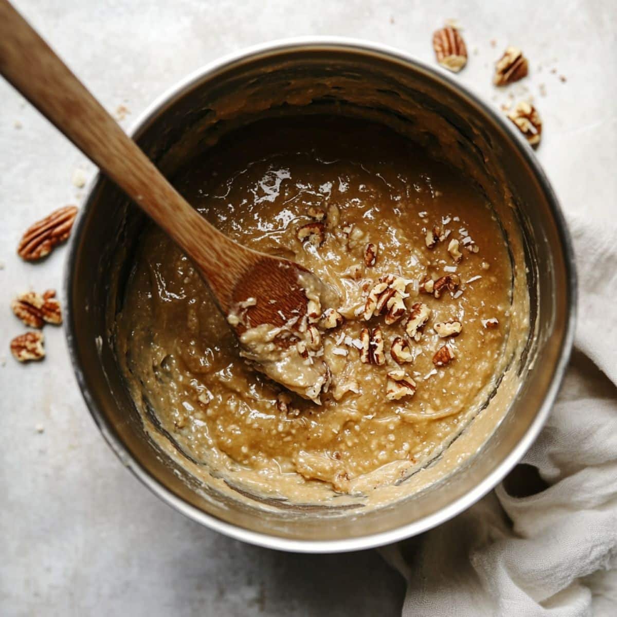 Cooking homemade coconut pecan frosting in saucepan	