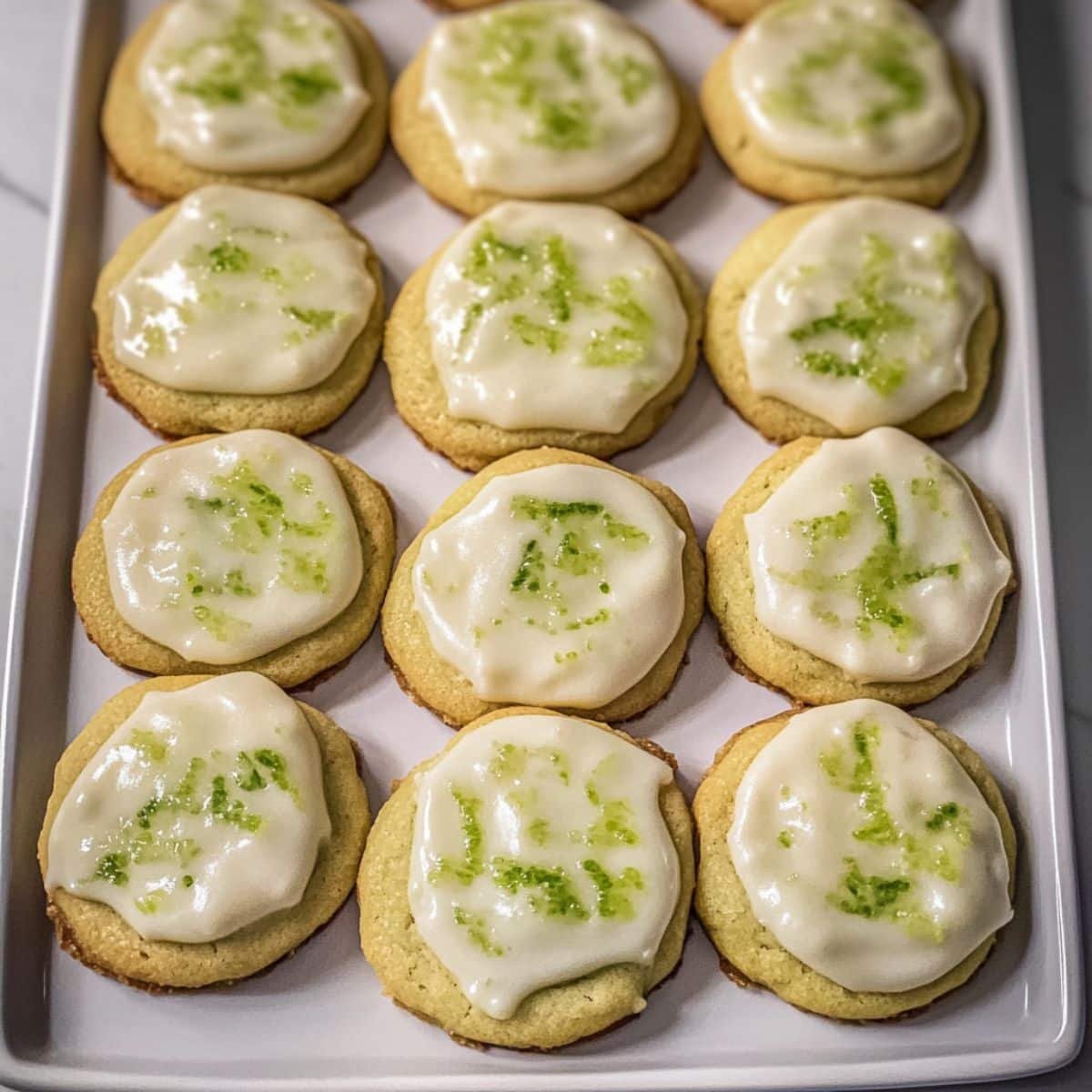 Overhead view of homemade key lime cookies with glaze and lime zest	
