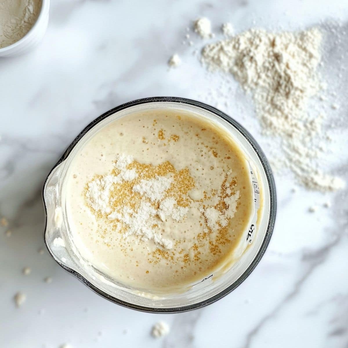 Gluten free crepes batter being mixed in a blender on a white counter.