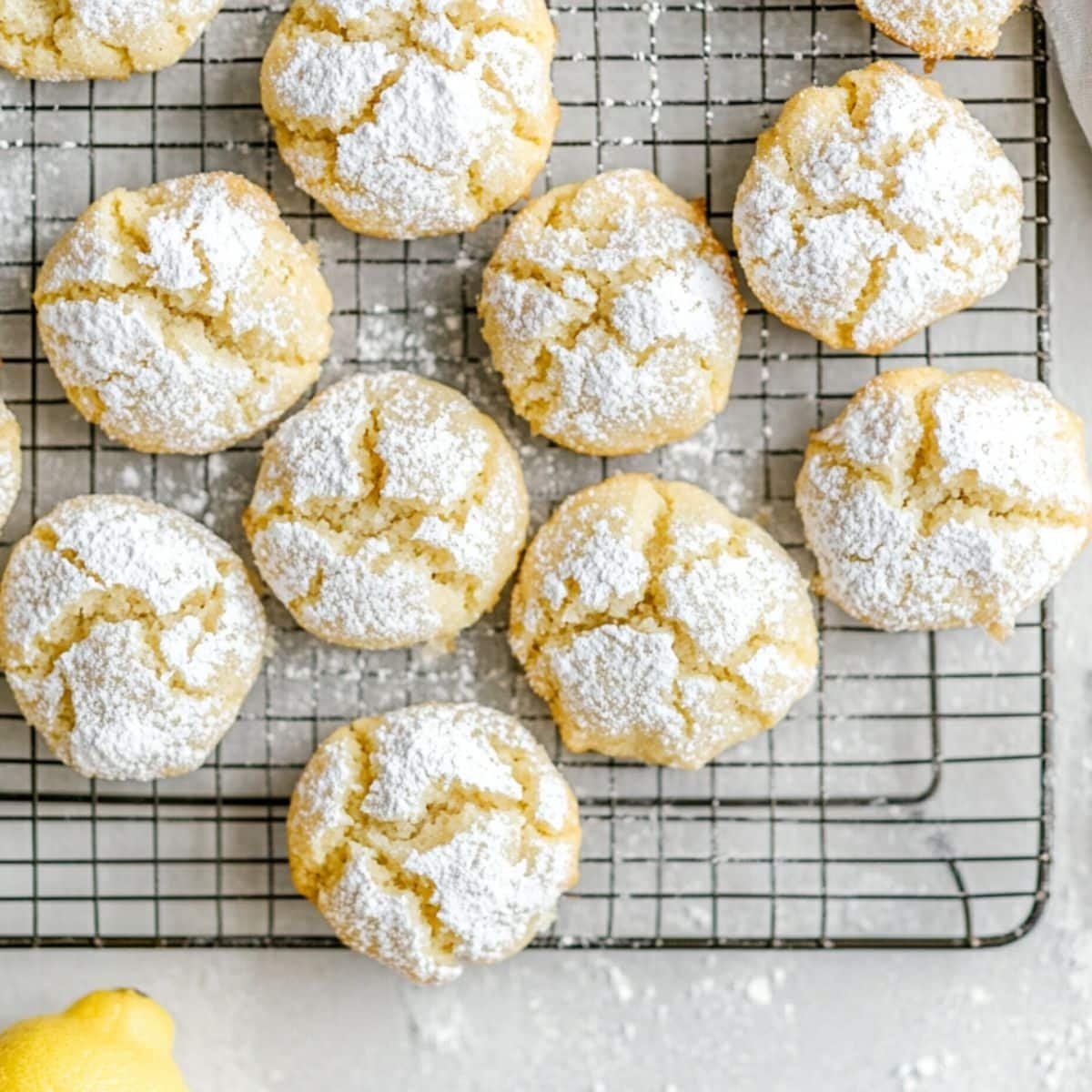 Fresh lemon crinkle cookies cooling on a wire rack