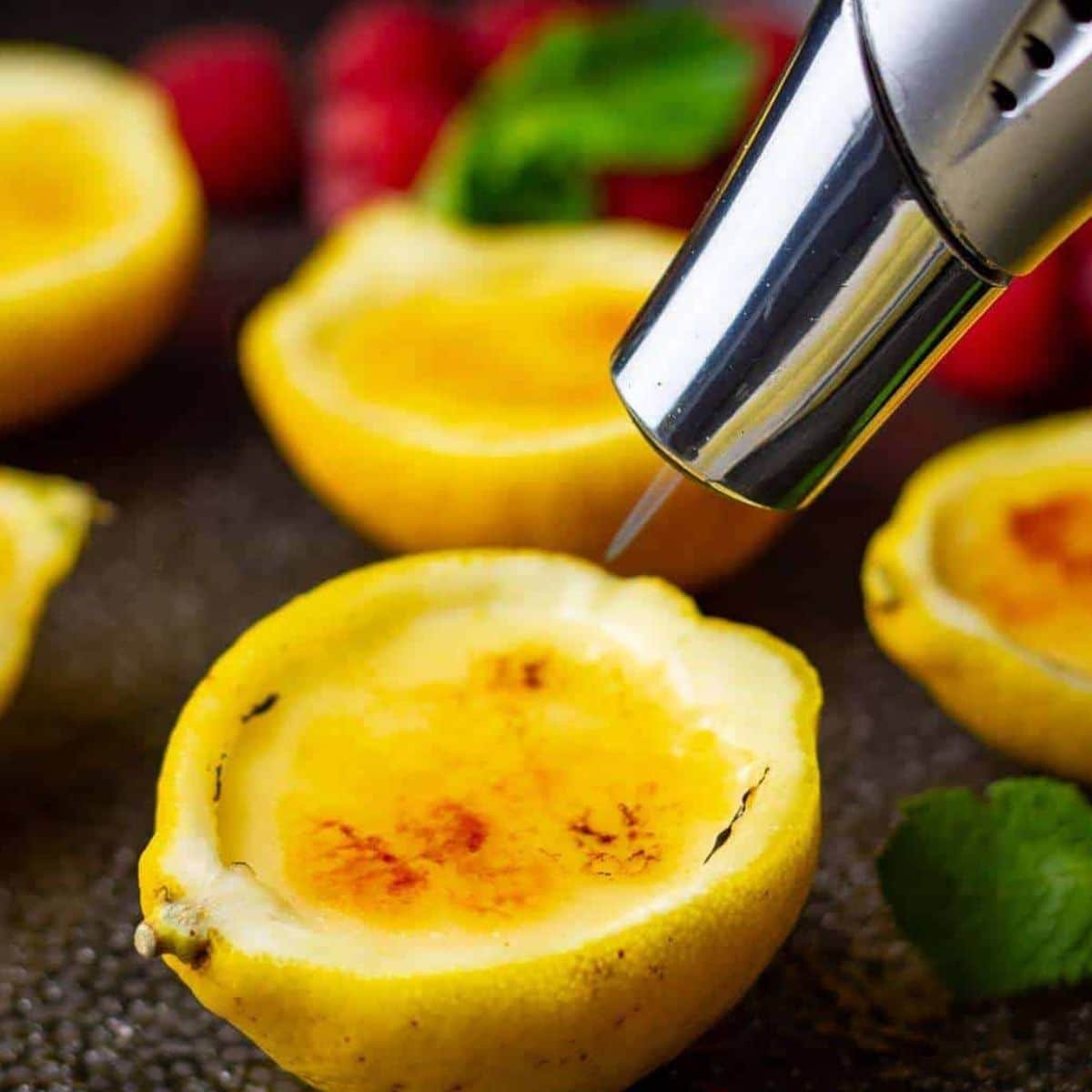 Torching sugar on lemon posset to create golden brulee topping	