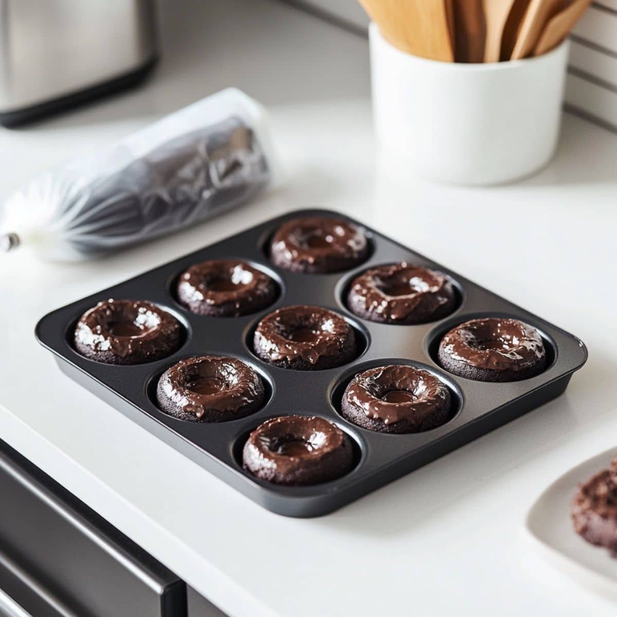 Mini chocolate donut pan filled with batter ready for the oven	