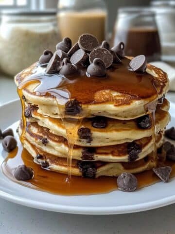 Stack of homemade chocolate chip pancakes with syrup and butter on top