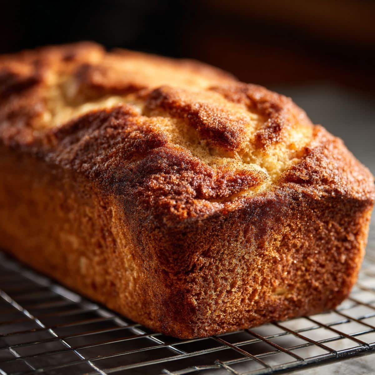 Fresh loaves of Amish Cinnamon Bread cooling on wire rack