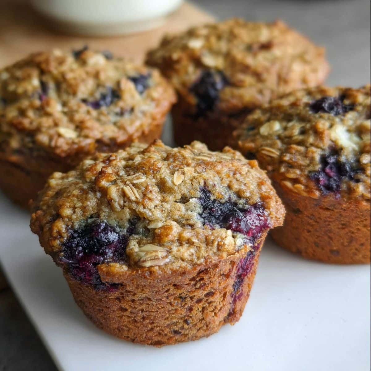 Banana blueberry oatmeal muffins with butter on top, rustic and homemade