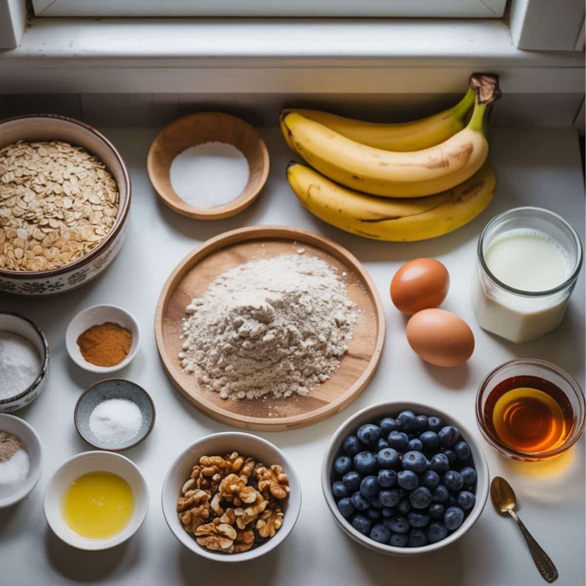 All ingredients laid out to make banana blueberry oatmeal muffins	
