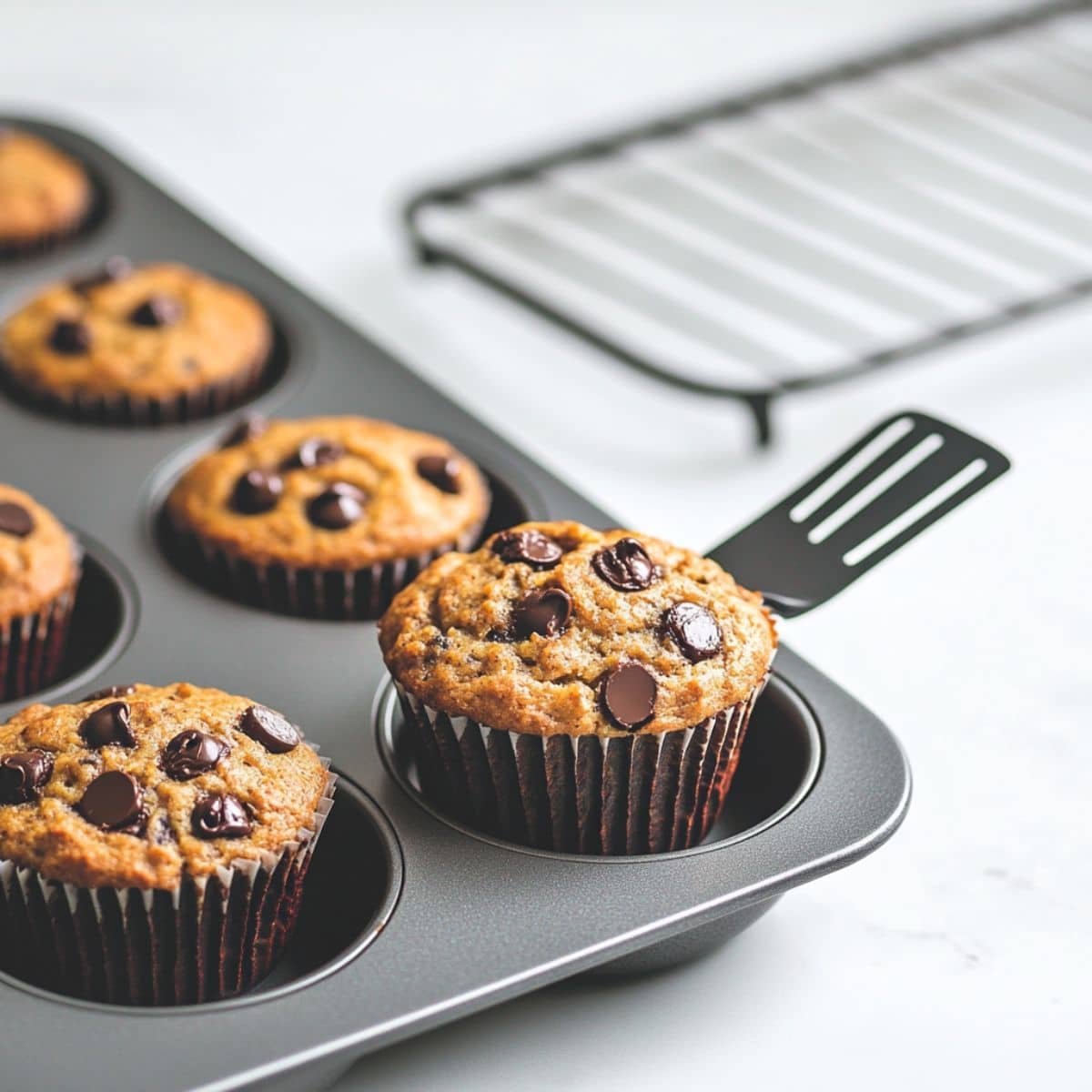 Freshly baked banana protein muffins cooling on the counter	