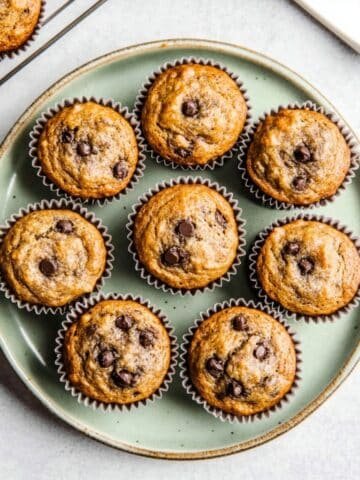 Top-down view of freshly baked Banana Protein Muffins cooling on a white kitchen counter