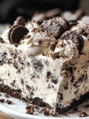 Slice of Cookies and Cream Ice Cream Cake lifted showing all layers, rustic and real