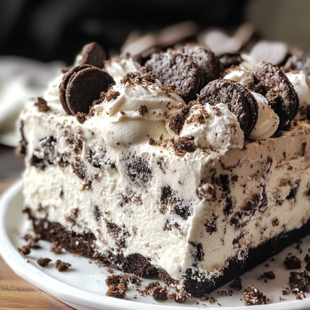Slice of Cookies and Cream Ice Cream Cake lifted showing all layers, rustic and real
