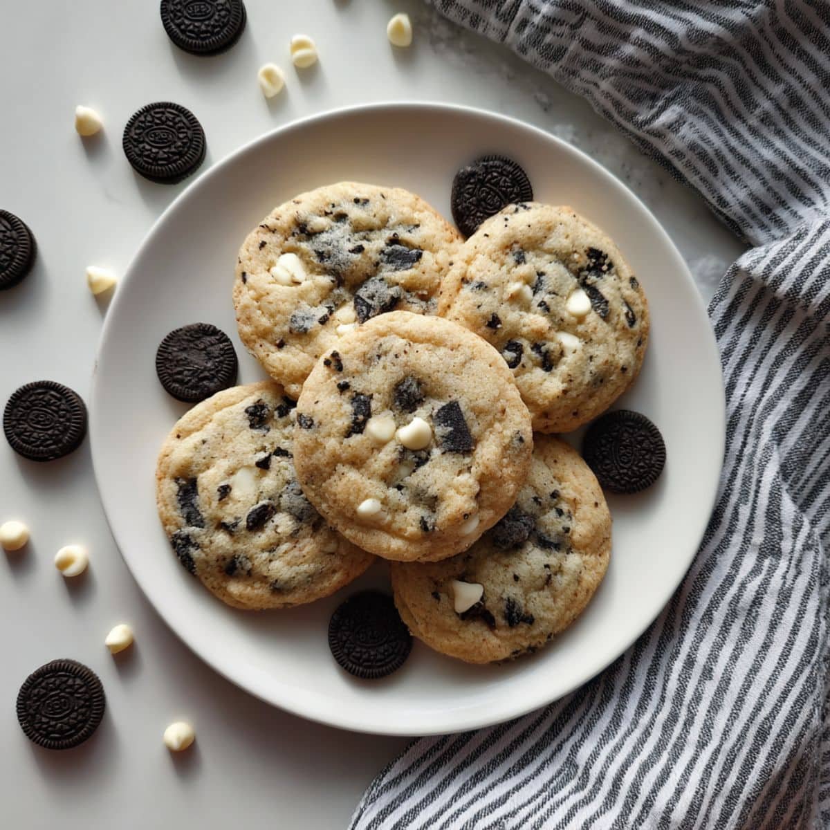 Soft cookies and cream cookies with Oreo chunks and white chocolate chips on parchment paper	