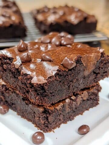 Homemade black bean brownies with chocolate chips on a white kitchen counter