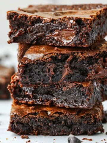 Stack of fudgy homemade cottage cheese brownies on white counter