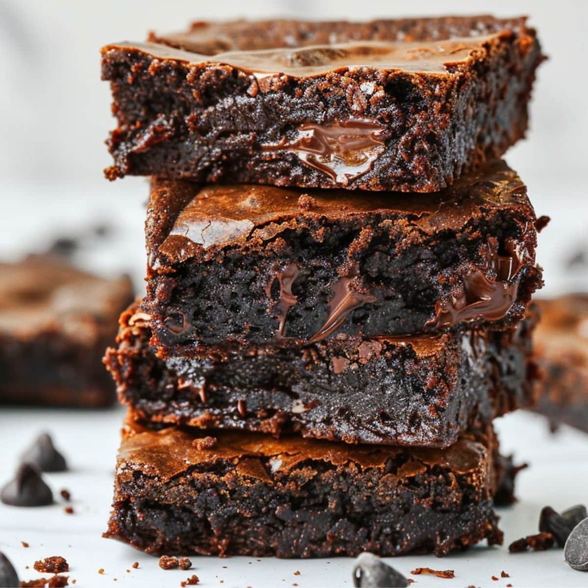 Stack of fudgy homemade cottage cheese brownies on white counter	
