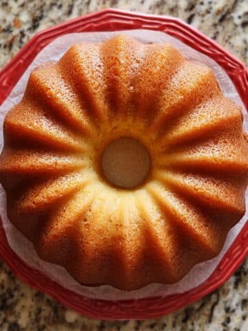 Homemade glazed Bundt Cake Recipes on a white counter with a slice cut out
