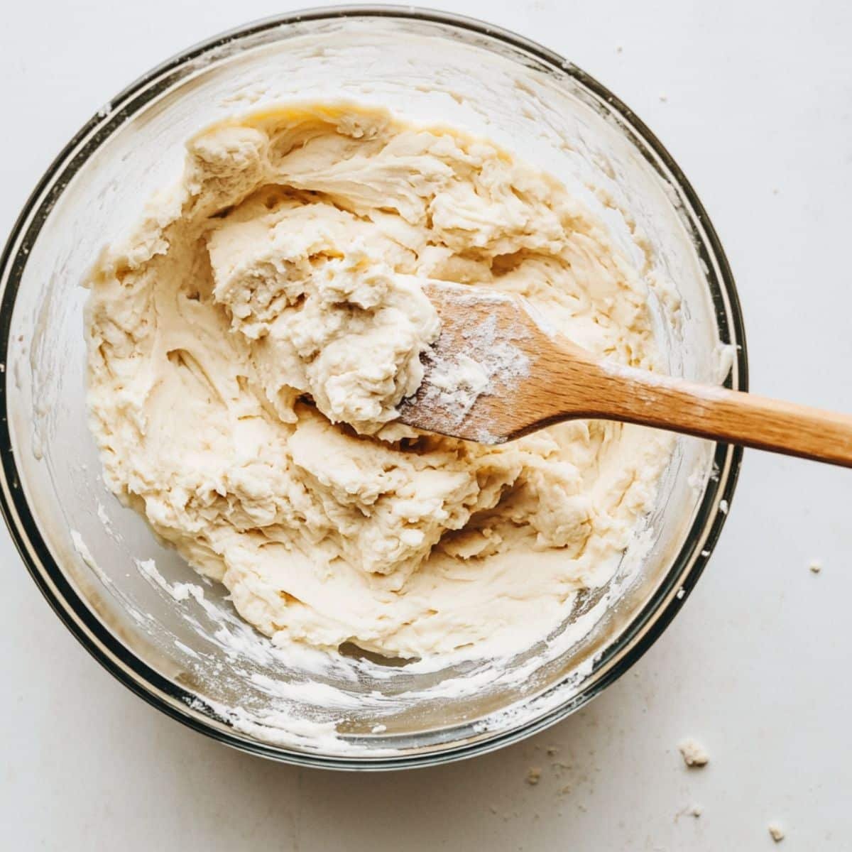 Cookie dough with visible lavender specks being mixed in a bowl	