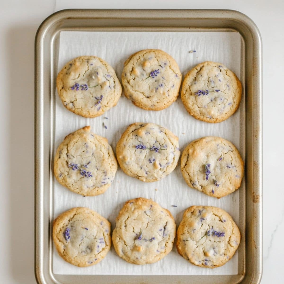 Lavender cookies baking on a tray, just out of the oven	