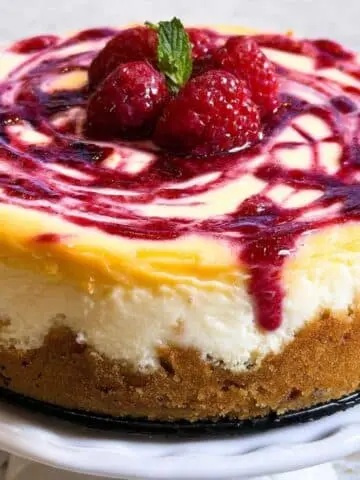 Top view of a homemade lemon raspberry cheesecake with a rustic swirl.