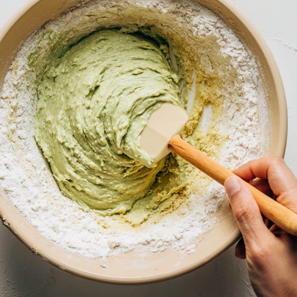 Combining dry ingredients into wet avocado mixture	
