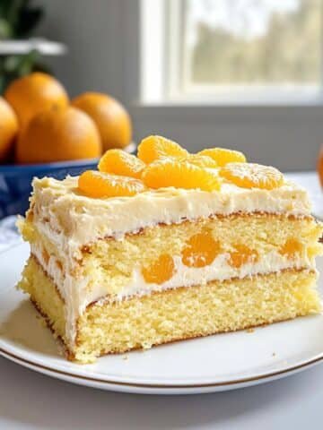 A homemade pig pickin cake with whipped pineapple frosting and mandarin slices on top