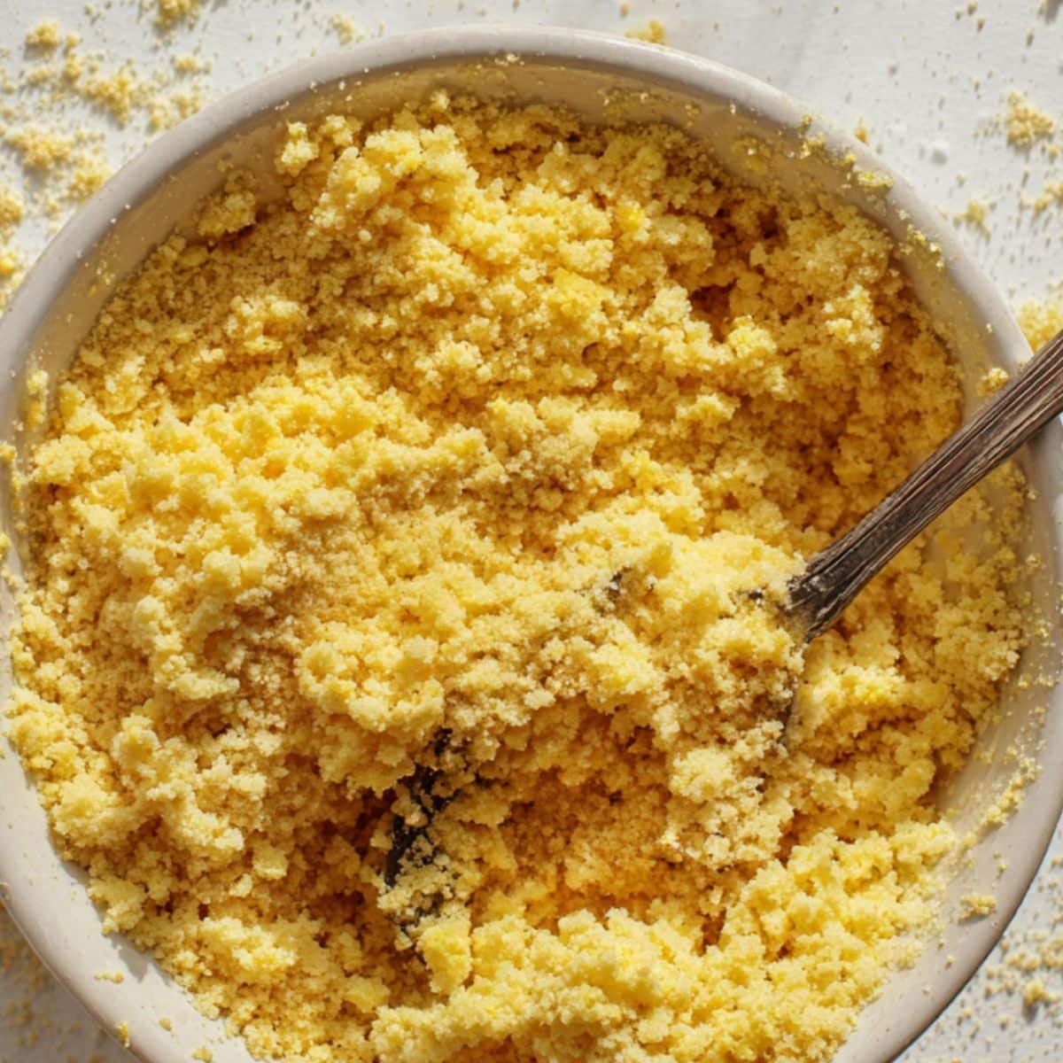 Sprinkling buttery cake-mix crumbles evenly over the cream-cheese and strawberry layers.	