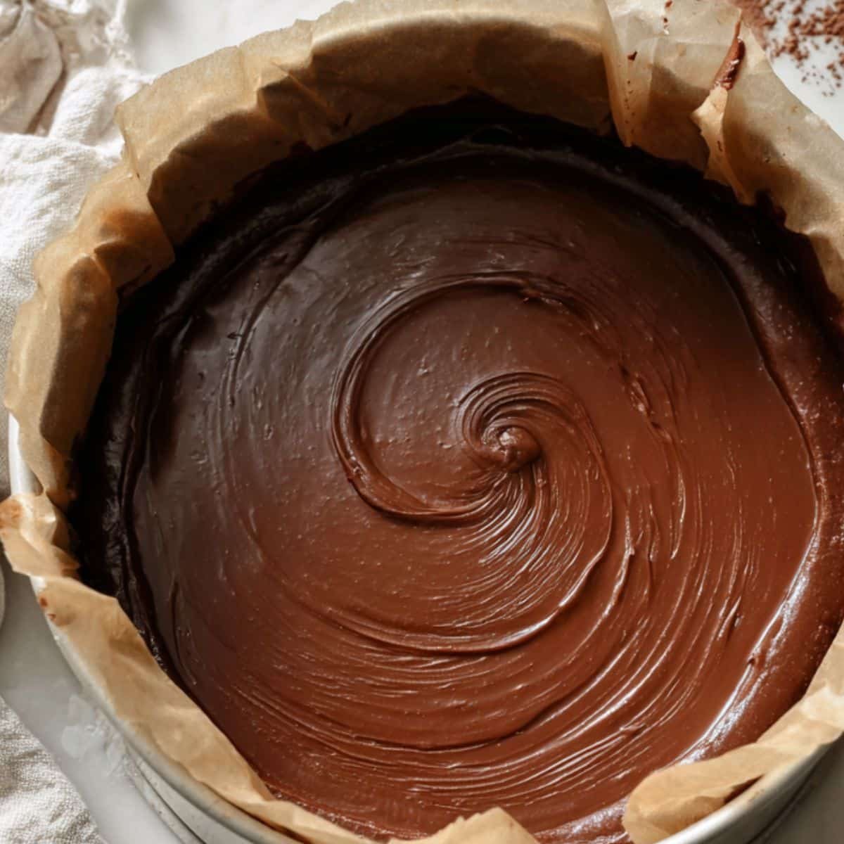 Chocolate batter poured into lined pan, ready for the oven