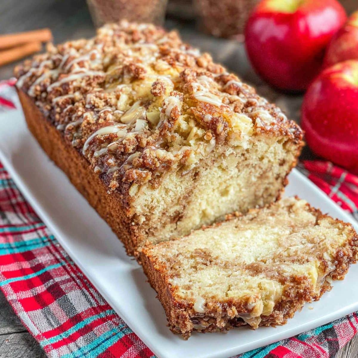 Sliced homemade apple pie bread on a white tray with cinnamon crust	