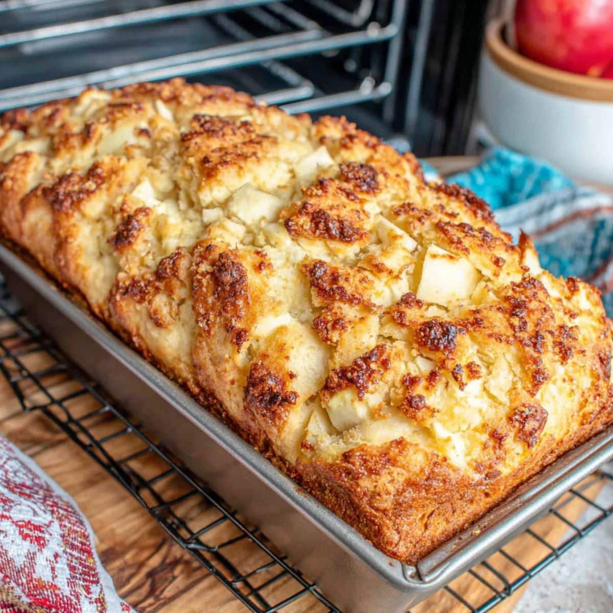 Apple pie bread baking in loaf pan inside a home oven	