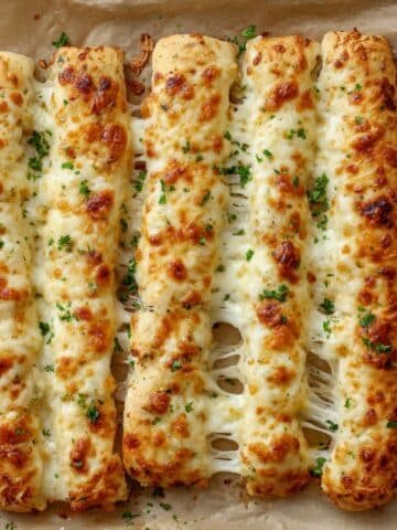 Gooey homemade Cheesy Breadsticks Recipe on tray