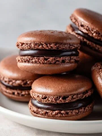 Close-up of chocolate macarons on white counter