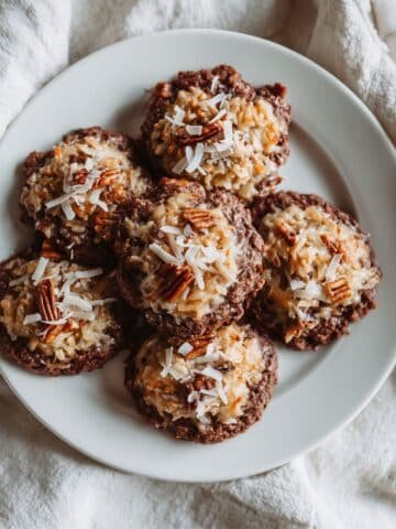 Homemade German Chocolate Cookies on white plate with gooey coconut pecan topping