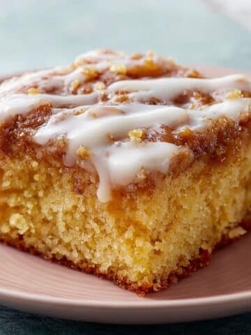 Glazed honey bun cake in a white baking dish on white countertop