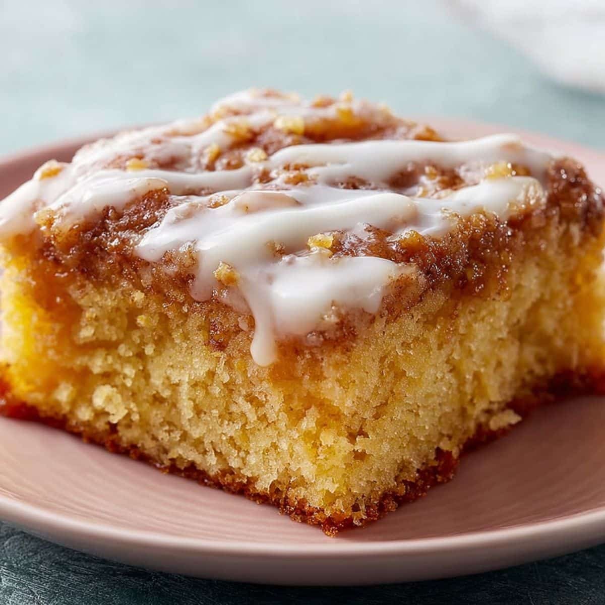Glazed honey bun cake in a white baking dish on white countertop	