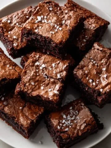 Freshly baked Nutella brownies cut into squares on white plate