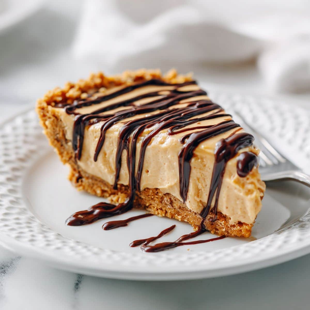 Slice of no bake peanut butter cheesecake on a plate	