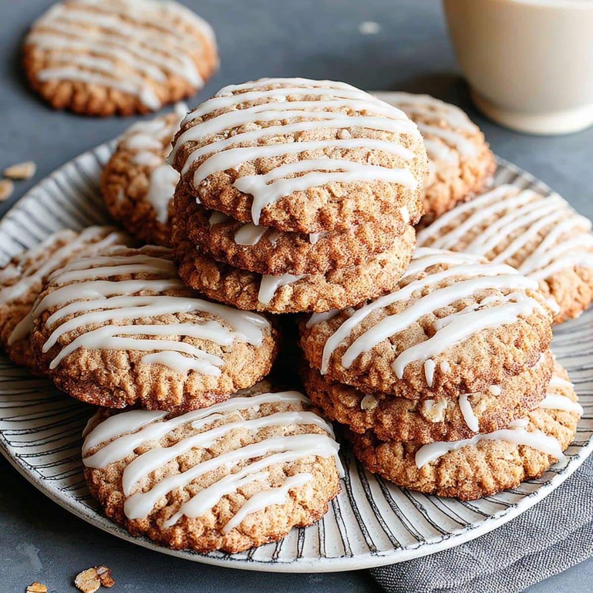 Frosted oatmeal cookies cooling on a rack with vanilla glaze