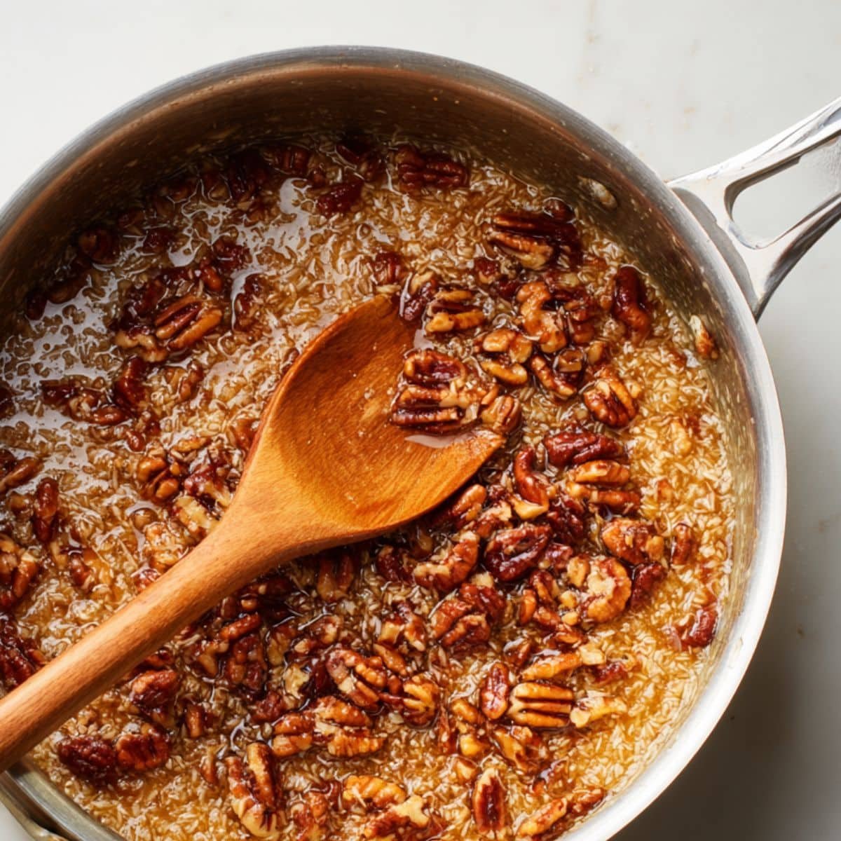 Cooking coconut pecan topping in a saucepan.	