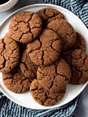 Crackled ginger molasses cookies on white counter