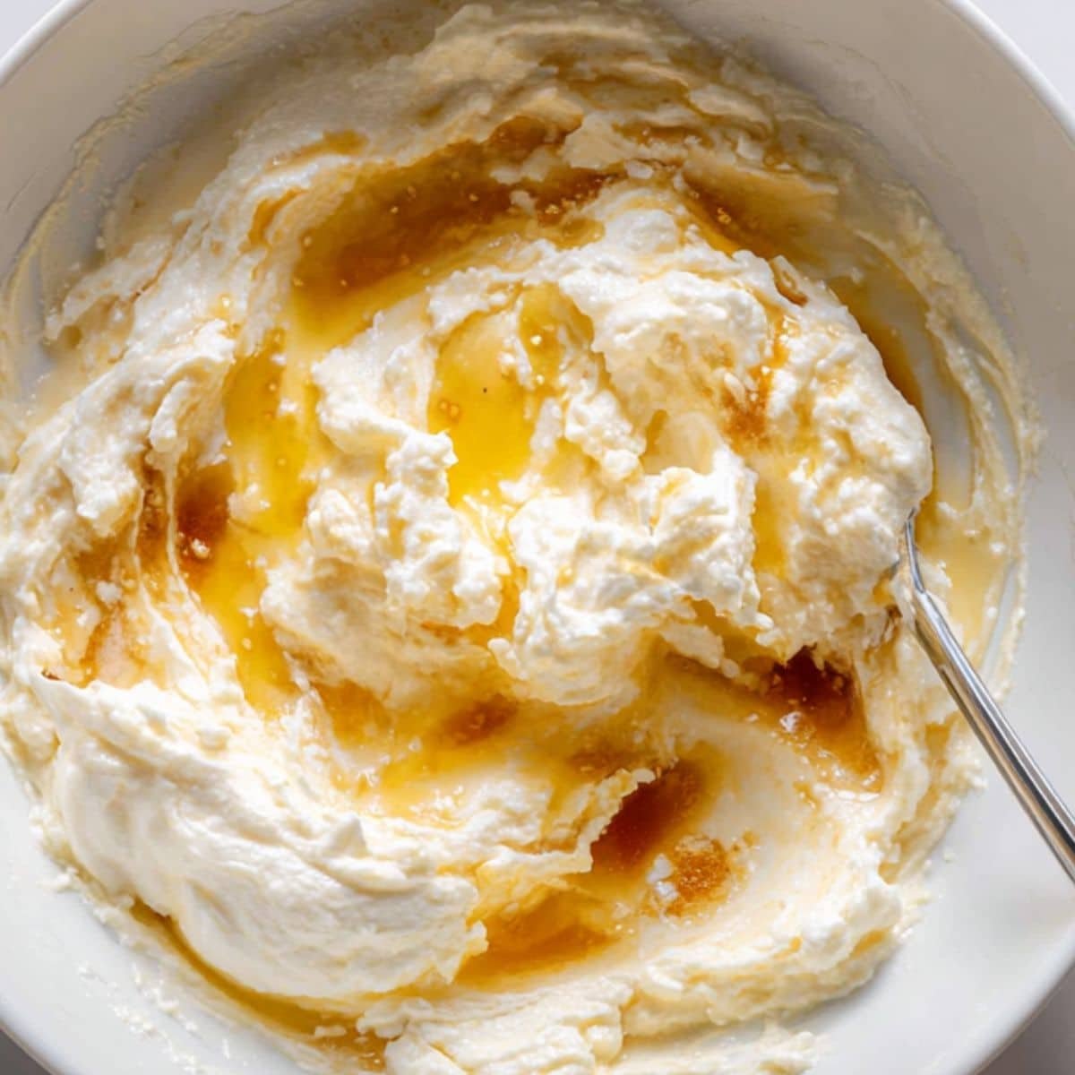 Mashed banana, Greek yogurt, eggs, and maple syrup being combined	
