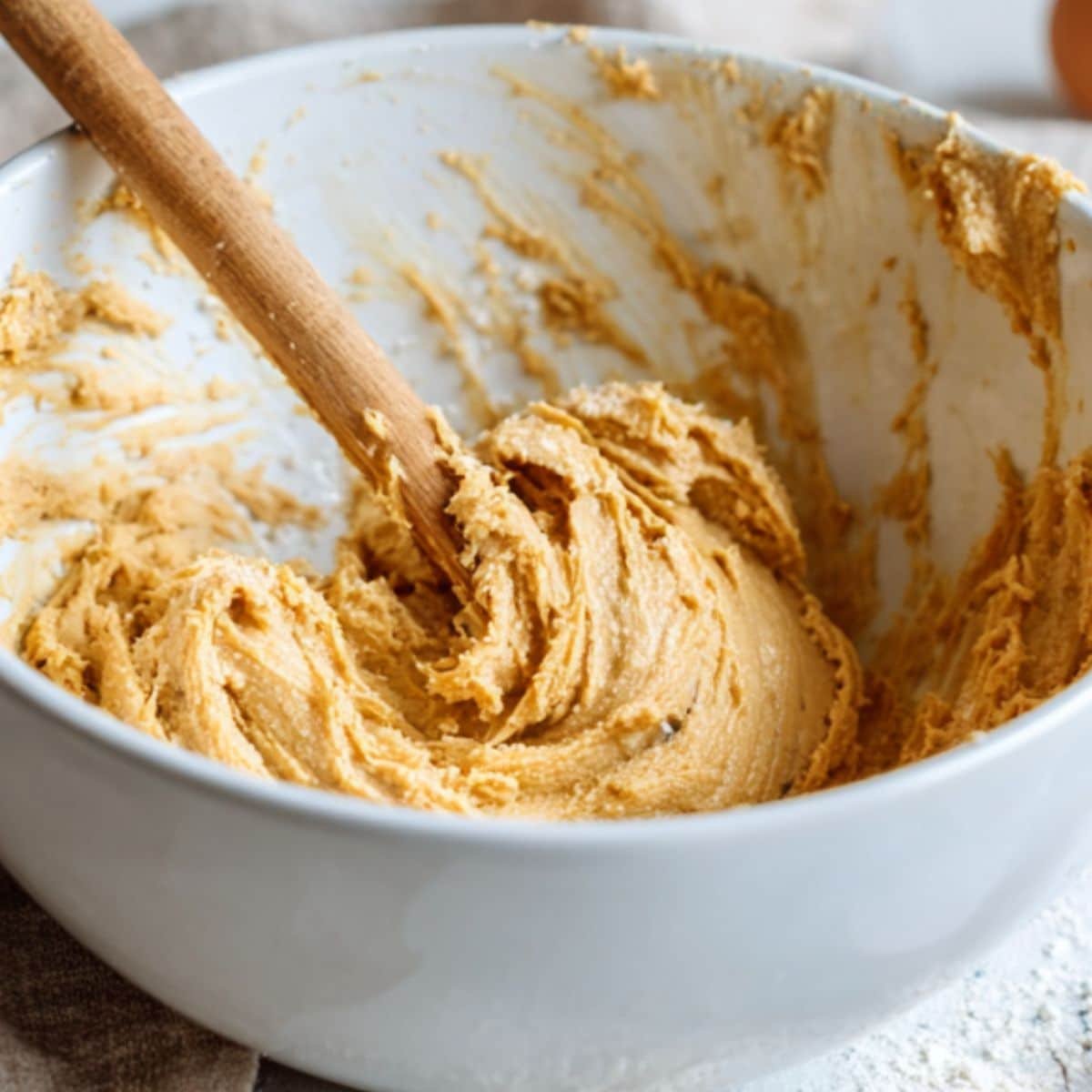 Mixing peanut butter cookie dough in a large bowl	