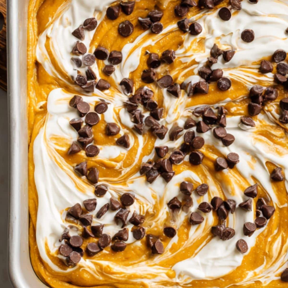 Adding chocolate chips and swirling cream cheese into batter	