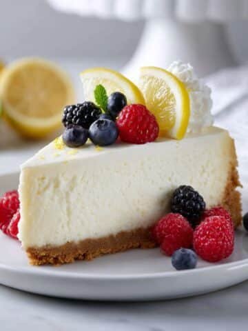 Slice of lemon-topped Ricotta Cheesecake No Bake on white stand